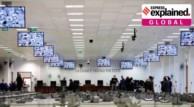 Some of the defendants in a trial against 355 suspected members of the 'Ndrangheta mafia, accused of an array of charges, are seen on screens as they join via video link on the first day of their trial, in a High Security Courthouse in Lamezia Terme, Italy, January 13, 2021. (Source: Reuters/Yara Nardi)