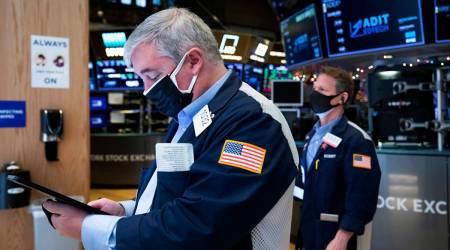 In this photo provided by the New York Stock Exchange, traders Edward MacCarthy, left, and Robert Charmak work on the trading floor, Tuesday, Jan. 12, 2021. (Colin Ziemer/New York Stock Exchange via AP)