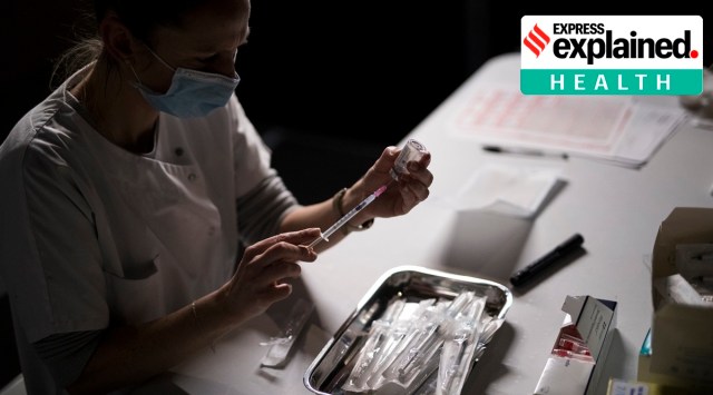 Nurse Coralie Ferron prepares a dose of the Moderna Covid-19 vaccine at a vaccination center in Le Cannet, southern France, Thursday Jan. 21, 2021. (AP Photo: Daniel Cole)