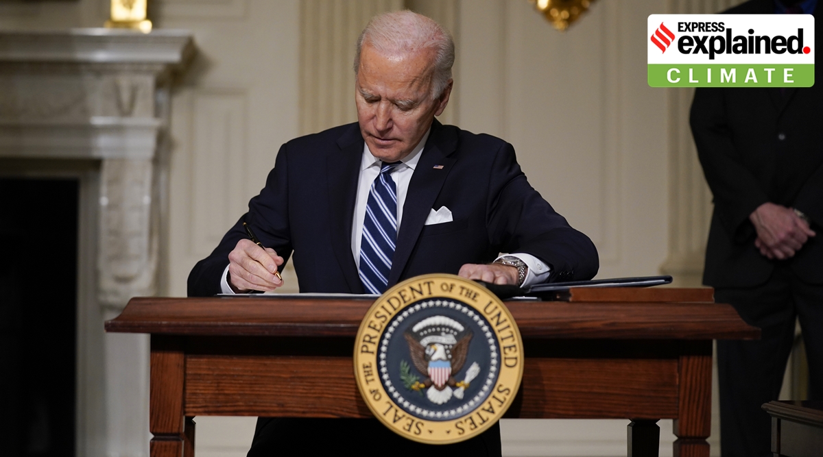 President Joe Biden signs an executive order on climate change, in the State Dining Room of the White House, Wednesday, Jan. 27, 2021, in Washington. (AP Photo/Evan Vucci)