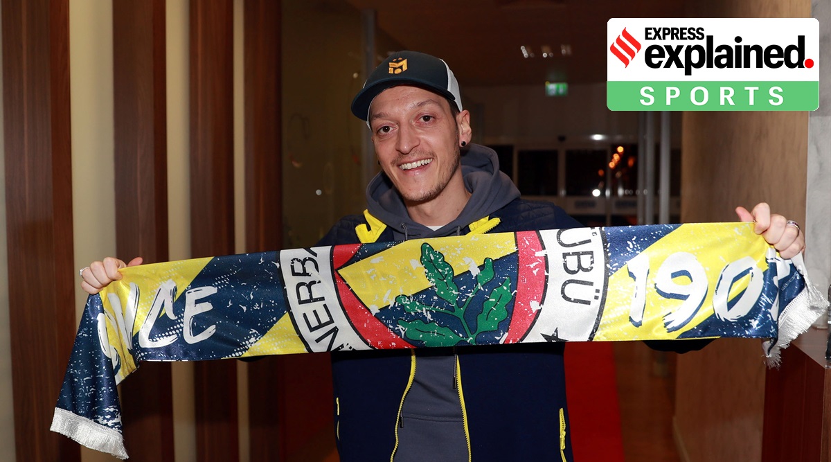 German midfielder Mesut Ozil poses with a Fenerbahce scarf upon his arrival at Ataturk Airport in Istanbul, Turkey, January 18, 2021. (Fenerbahce.org/Handout via Reuters)