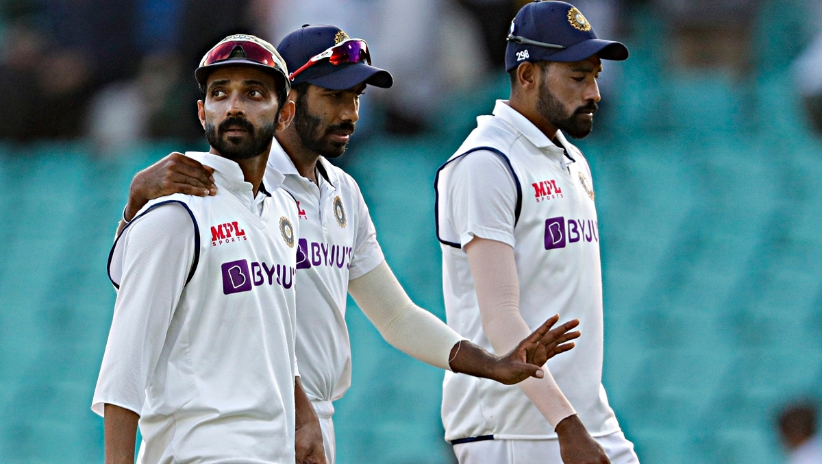 Ajinkya Rahane walks from the field with teammate Jasprit Bumrah. (AP)