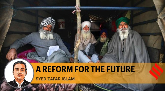 Farmers sit at the back of their tractor trolley as they continue to block a highway at the Delhi- Haryana border at the outskirts of New Delhi. (AP Photo/Manish Swarup)