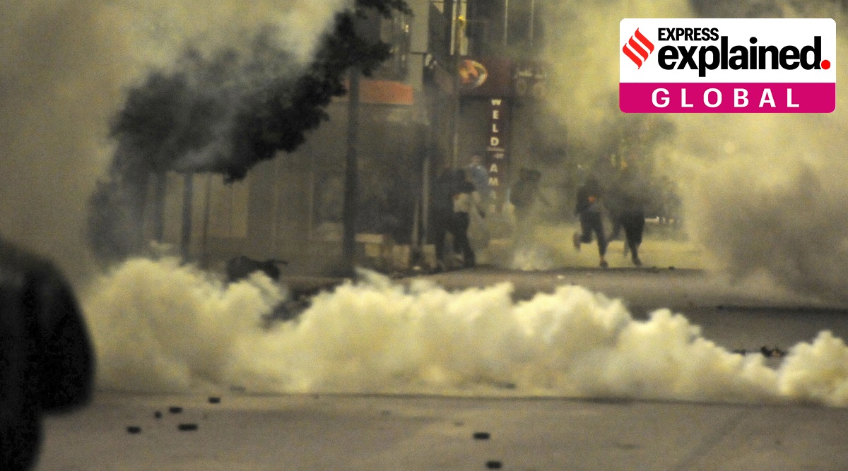 Demonstrators face police officers during clashes in Ettadhamen City near Tunis, Tuesday, Jan. 19, 2021. (AP Photo: Hassene Dridi)