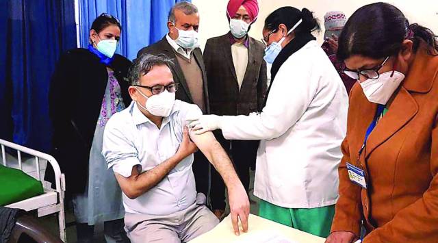 Patiala Civil Surgeon Dr Satinder Singh gets a shot, Saturday. (Express photo by Harmeet Sodhi)