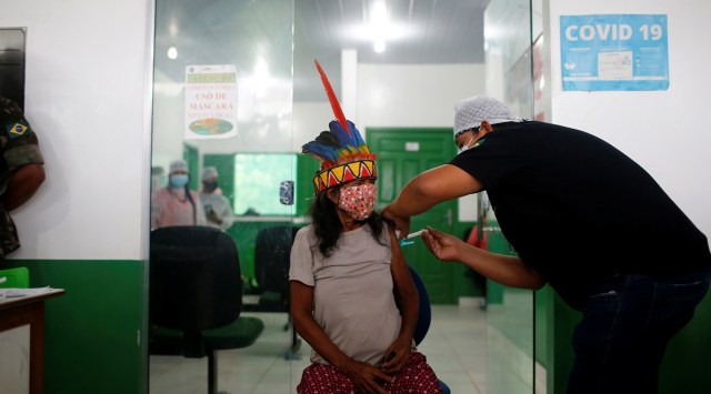 An indigenous woman of the Ticuna tribe receives a Sinovac coronavirus disease (COVID-19) vaccine shot, in Tabatinga, state of Amazonas, Brazil, January 19, 2021. (Reuters Photo: Adriano Machado)