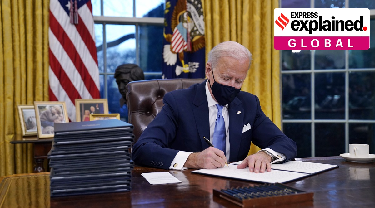 President Joe Biden signs his first executive order in the Oval Office of the White House on Wednesday, in Washington. (AP Photo)