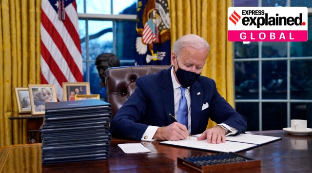 President Joe Biden signs his first executive order in the Oval Office of the White House on Wednesday, in Washington. (AP Photo)