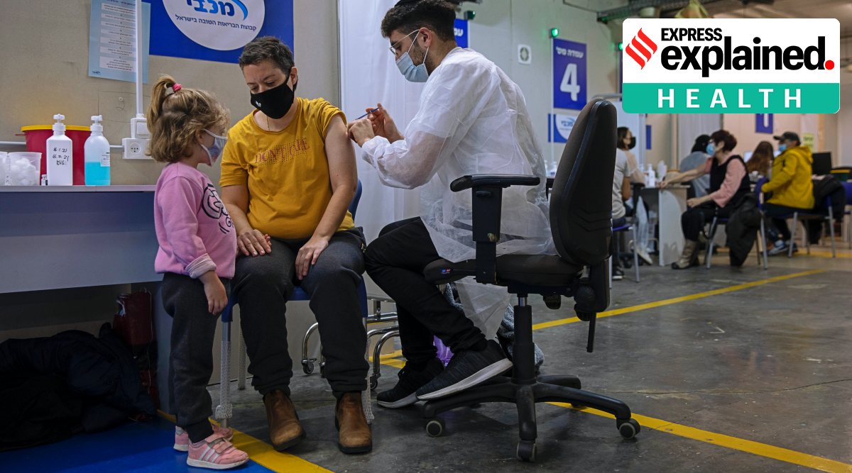 Israelis receive a Pfizer-BioNTech COVID-19 vaccine from medical professionals at a vaccination center set up on a mall parking lot in Givataim. (AP)
