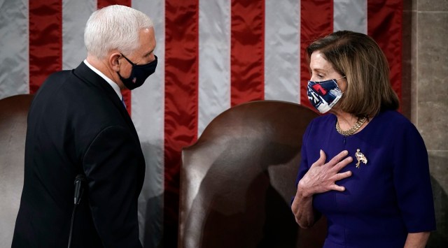 Speaker of the House Nancy Pelosi, D-Calif., and Vice President Mike Pence talk before a joint session of the House and Senate convenes to count the Electoral College votes cast in November's election, at the Capitol in Washington, Wednesday, Jan. 6, 2021. (AP Photo/J. Scott Applewhite)