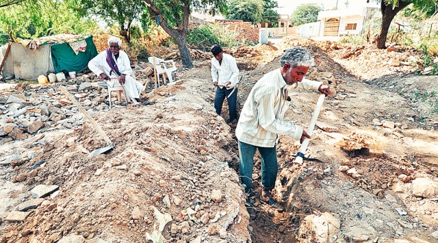 Manji Meriya (centre) digs the foundation of his old house that had collapsed in the 2001earthquake. (Photo: Nirmal Harindran)