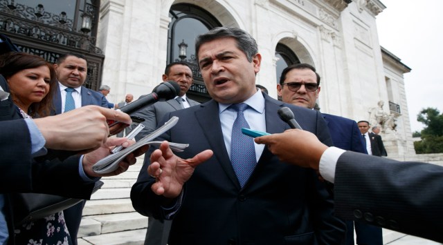 In this Aug. 13, 2019 file photo, Honduran President Juan Orlando Hernandez speaks to the reporters as he leaves a meeting at the Organization of American States, in Washington. (AP Photo/Jacquelyn Martin, File)