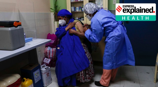 A health worker is injected with the Sinopharm COVID-19 vaccine at the children's Hospital del Nino in La Paz, Bolivia, Friday, Feb. 26, 2021. (AP Photo/Juan Karita)