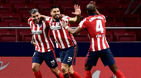Atletico Madrid's Luis Suarez, center, celebrates with teammates after scoring during a La Liga match.