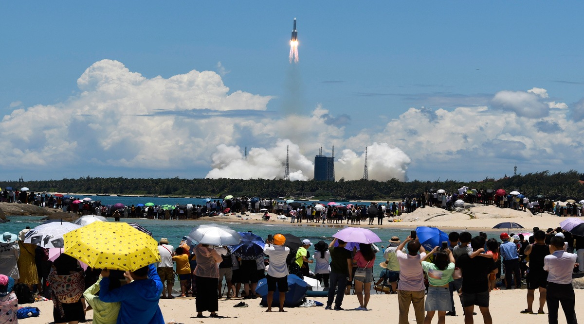 In this July 23, 2020, file photo released by China's Xinhua News Agency, spectators watch as a Long March-5 rocket carrying the Tianwen-1 Mars probe lifts off from the Wenchang Space Launch Center in southern China's Hainan Province. (Yang Guanyu/Xinhua via AP, File)