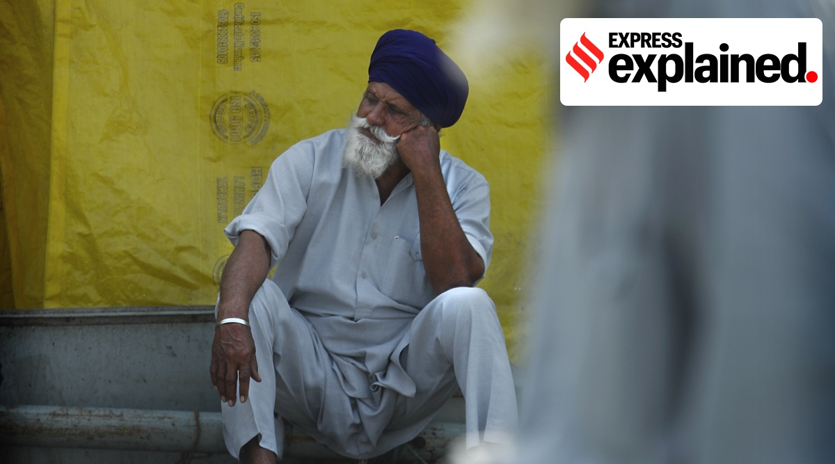 A farmer sits at the Delhi border in protest against the new farm laws, on Tuesday, Feb. 23, 2021. (AP Photo/Manish Swarup, File)