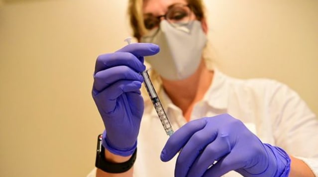 This September 2020, file photo provided by Johnson & Johnson shows a pharmacist preparing to give an experimental COVID-19 vaccine.  (Johnson & Johnson via AP, File)
