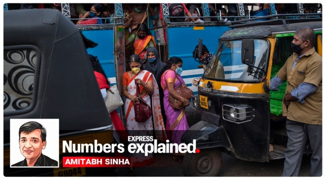 People wearing masks as a precaution against the coronavirus alight from a bus in Kochi. (AP Photo/R S Iyer)