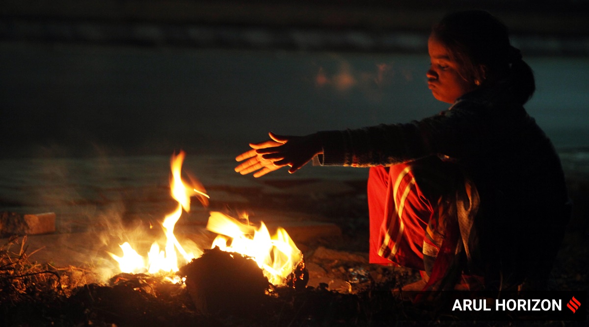 A street kid seen warming herself besides fire at Wanowrie in Pune (Express File Photo by Arul Horizon)