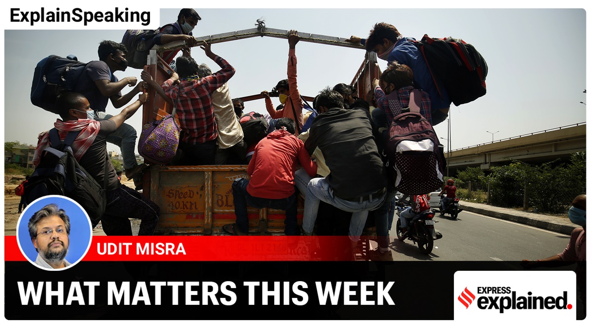 Migrants rush to get inside a transport to reach their hometown in Uttar Pradesh (Express photo/Praveen Khanna)
