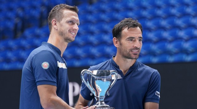 Croatia's Ivan Dodig, right, and Slovakia's Filip Polasek pose with their trophy after defeating Rajeev Ram of the US and Britain's Joe Salisbury in the men's doubles final at the Australian Open tennis championship in Melbourne (Source: AP)
