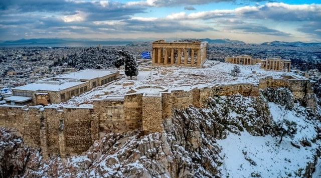 Athens, Acropolis, Rare snowfall, Athens snowfall, Snow-covered Athens, Snow in Acropolis, Acropolis in snow pictures, Videos of rare snowfall in Athens, Greece snowfall video, Athens rare snowfall in pictures, Snowfall viral video, Trending news, Indian express news