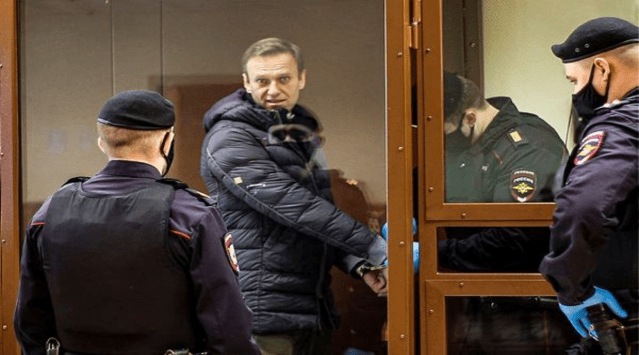 Russian opposition leader Alexei Navalny, center, enters a cage to attend a hearing on his charges for defamation in the Babuskinsky District Court in Moscow, Russia. (AP/PTI)
