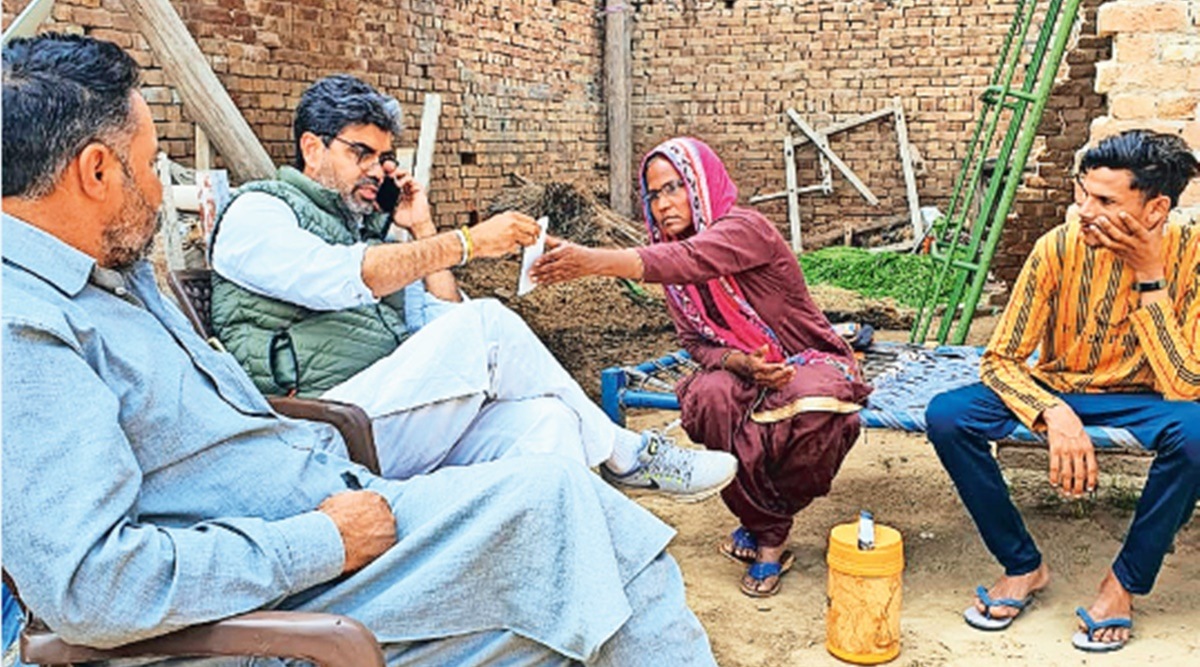 Nodeep Kaur’s mother Swarnjeet Kaur talks to Congress leader Jaijeet Singh Johal at her home in Gandhar village of Muktsar district, Punjab.  (Express Photo)