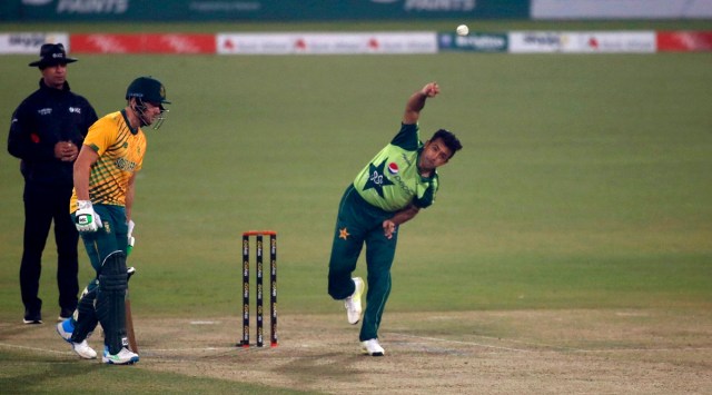 Pakistan's Zahid Mahmood, right, bowls while South Africa's David Miller watches during the 3rd Twenty20 cricket match between Pakistan and South Africa at the Gaddafi Stadium, in Lahore, Pakistan, Sunday, Feb. 14, 2021. (AP Photo/K.M. Chaudary)