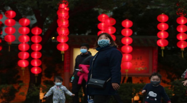 People wear face masks to help curb the spread of the coronavirus view lanterns hanging for Lantern Festival, marking the end to the Chinese lunar New Year celebrations in Taipei, Taiwan, Friday, Feb, 26, 2021. (AP Photo/Chiang Ying-ying)