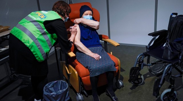 A woman receives her first dose of the AstraZeneca COVID-19 vaccine in a mass vaccination site at the Brabanthal event center in Heverlee, Belgium (AP)