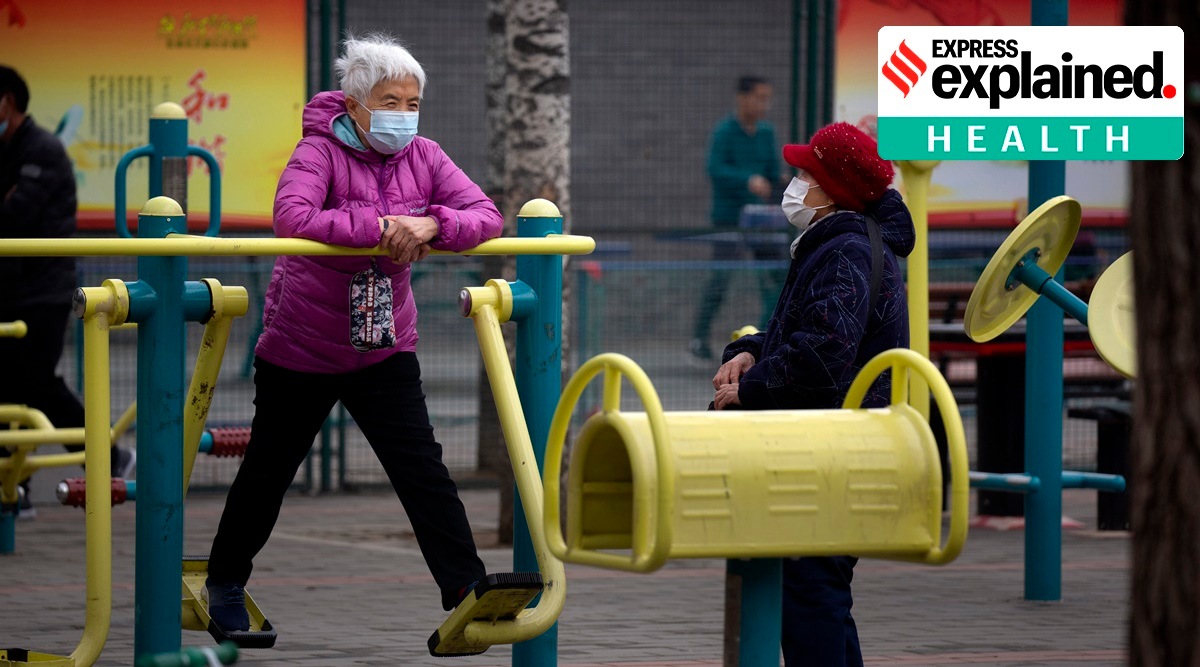 A woman wearing a face mask to protect against the coronavirus uses an exercise machine at a public park in Beijing (AP)