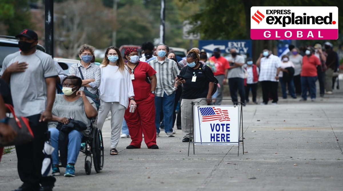 In this Oct. 12, 2020, file photo, people wait in line for early voting at the Bell Auditorium in Augusta, Ga. (Michael Holahan/The Augusta Chronicle)