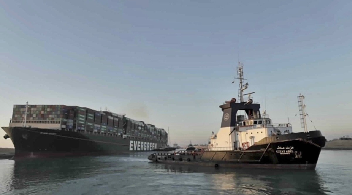 In this photo released by Suez Canal Authority, the Ever Given, a Panama-flagged cargo ship is pulled by one of the Suez Canal tugboats, in the Suez Canal, Egypt, Monday, March 29, 2021. (Suez Canal Authority via AP)