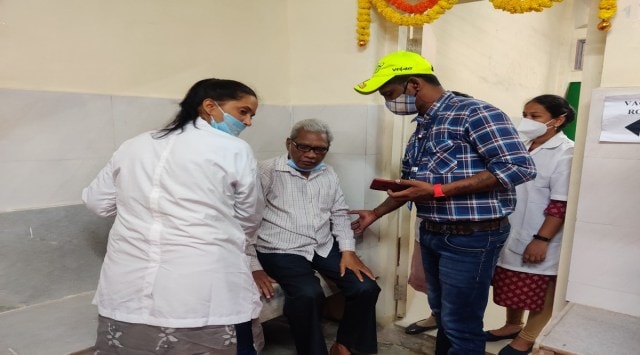Doctors check Ashok Gopal's vitals after he complains of giddiness post vaccination. (Express Photo by Tabassum Barnagarwala)