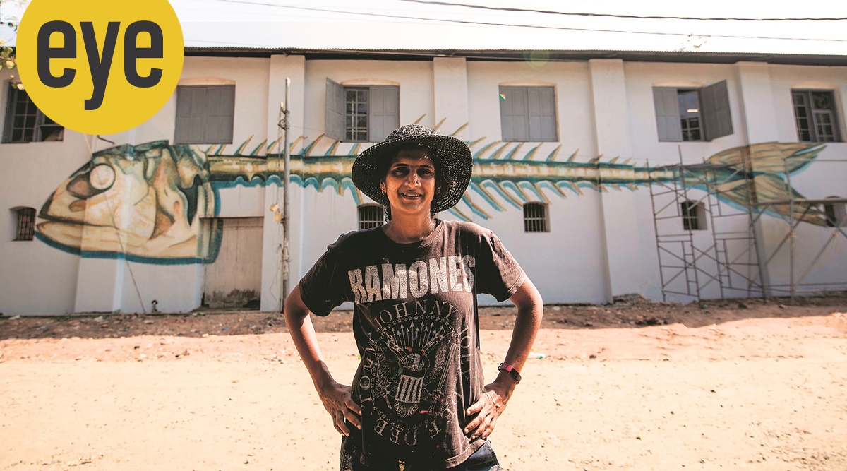 Anpu Varkey in front of one of her graffitis.