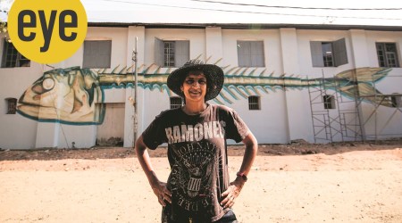 Anpu Varkey in front of one of her graffitis.