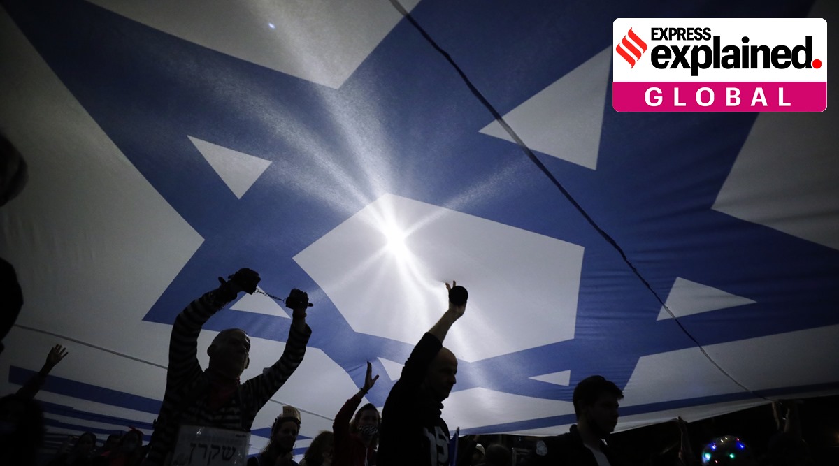 Protesters carry large Israeli flag during a demonstration against Israeli Prime Minister Benjamin Netanyahu In Jerusalem. (AP Photo/Sebastian Scheiner, File)