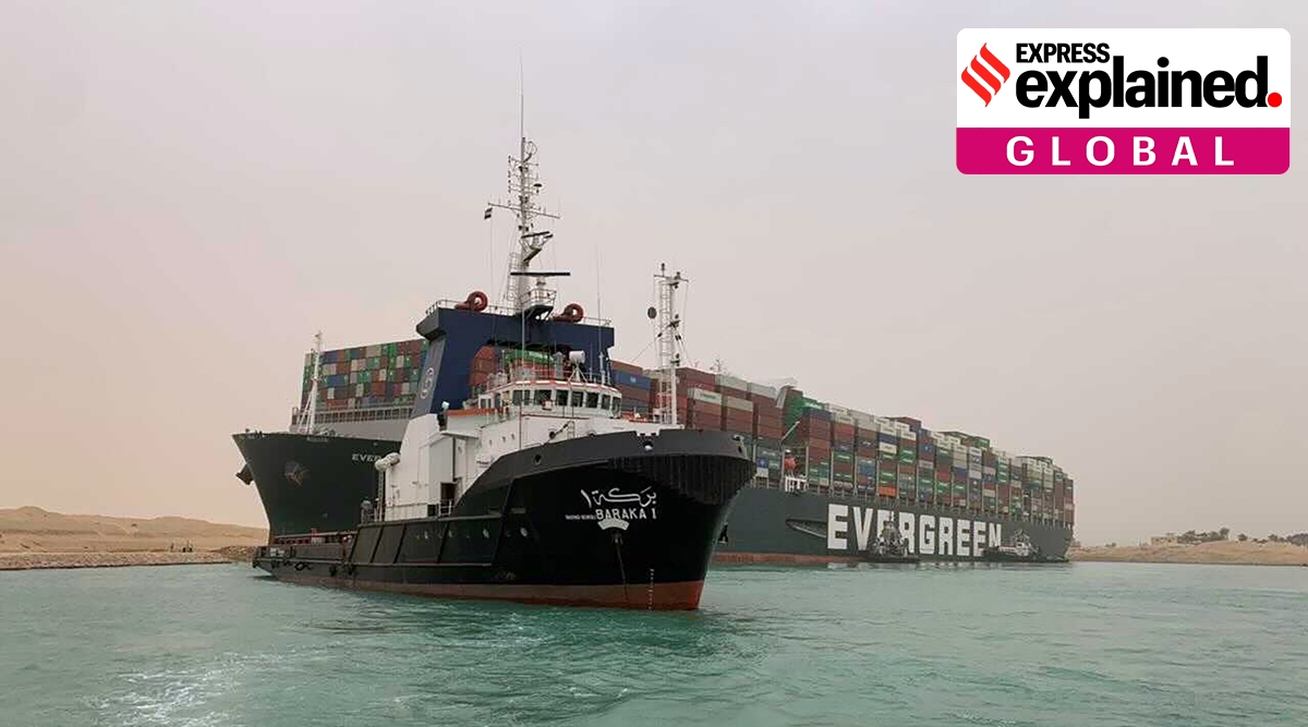 A boat navigates in front of a cargo ship, Ever Green, after it become wedged across Egypt’s Suez Canal and blocked all traffic in the vital waterway. (AP)

