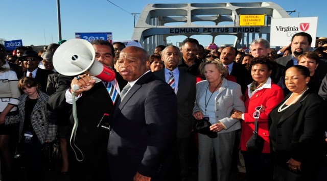 In this March 4, 2012, file photo, U.S. Rep. John Lewis, D-Ga., center, talks with those gathered on the historic Edmund Pettus Bridge during the 19th annual reenactment of the "Bloody Sunday" Selma to Montgomery civil rights march across the bridge in Selma. (Source AP)