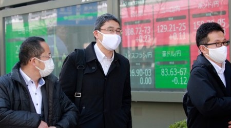 People walk by an electronic stock board of a securities firm in Tokyo, Wednesday, March 10, 2021. (AP Photo/Koji Sasahara)