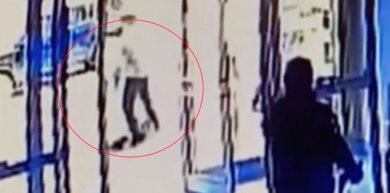 This image taken from surveillance video provided by the New York City Police Department shows a person of interest, background center, assaulting an Asian American woman, on ground, Monday, March 29, 2021, in New York. (Courtesy of New York Police Department via AP)