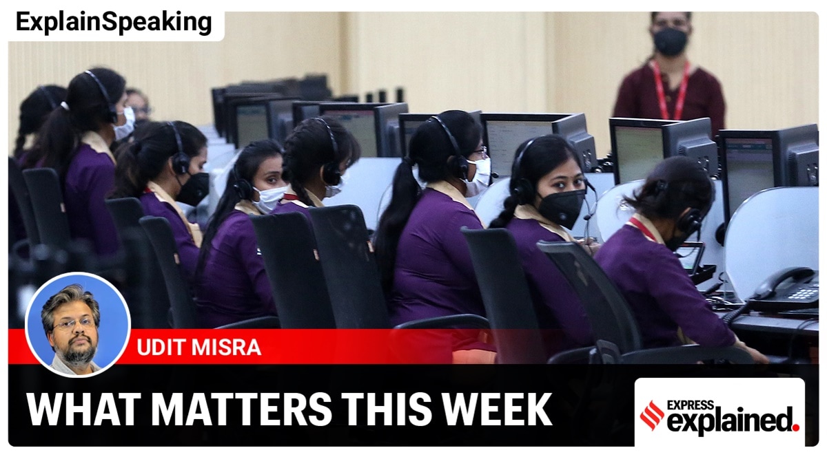 Workers wearing protective masks sit on their terminals inside a call centre in Uttar Pradesh (Express photo by Vishal Srivastav)