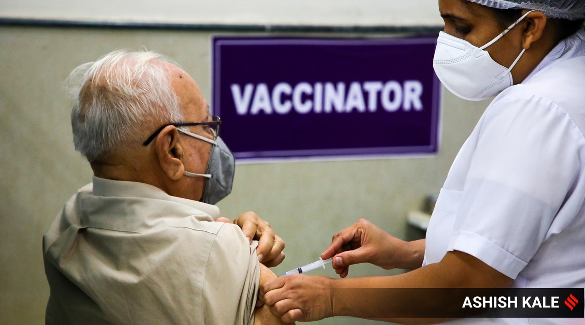A senior citizen takes the first shot of Covid Vaccine at Aundh district hospital. (Express photo by Ashish Kale)