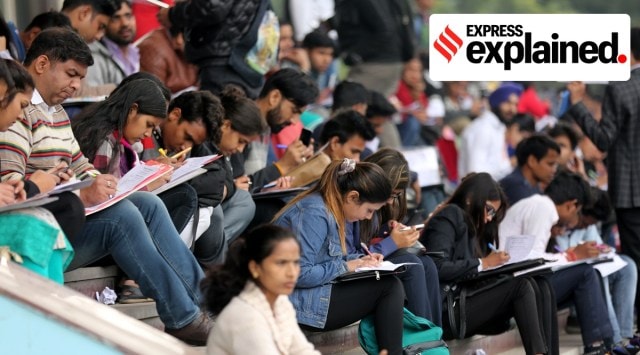Job seekers fill in registration forms at a job mela at Thyagaraj Stadium, in New Delhi, Jan 2019. (Express Photo: Tashi Tobgyal)