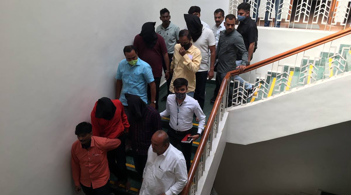 Arrested suspects (faces covered) at Pune police commissioner office on Tuesday.