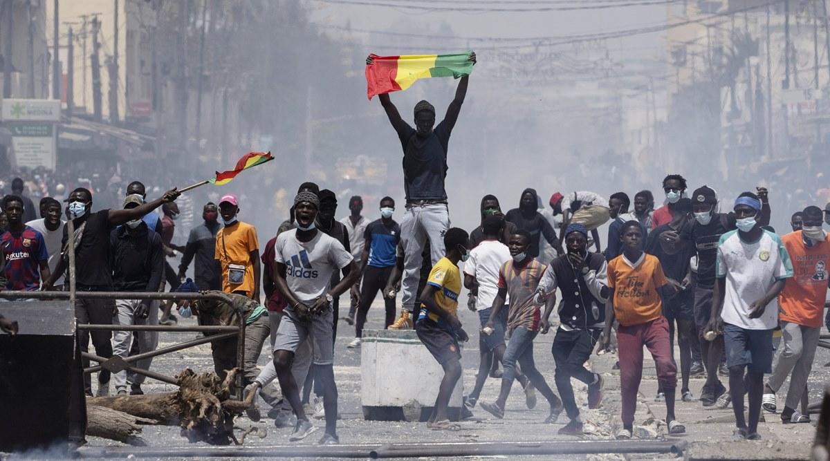 A demonstrator holds up a Senegalese flag during protests against the arrest of opposition leader and former presidential candidate Ousmane Sonko in Dakar, Senegal, Friday, March 5, 2021. (AP Photo/Leo Correa)
