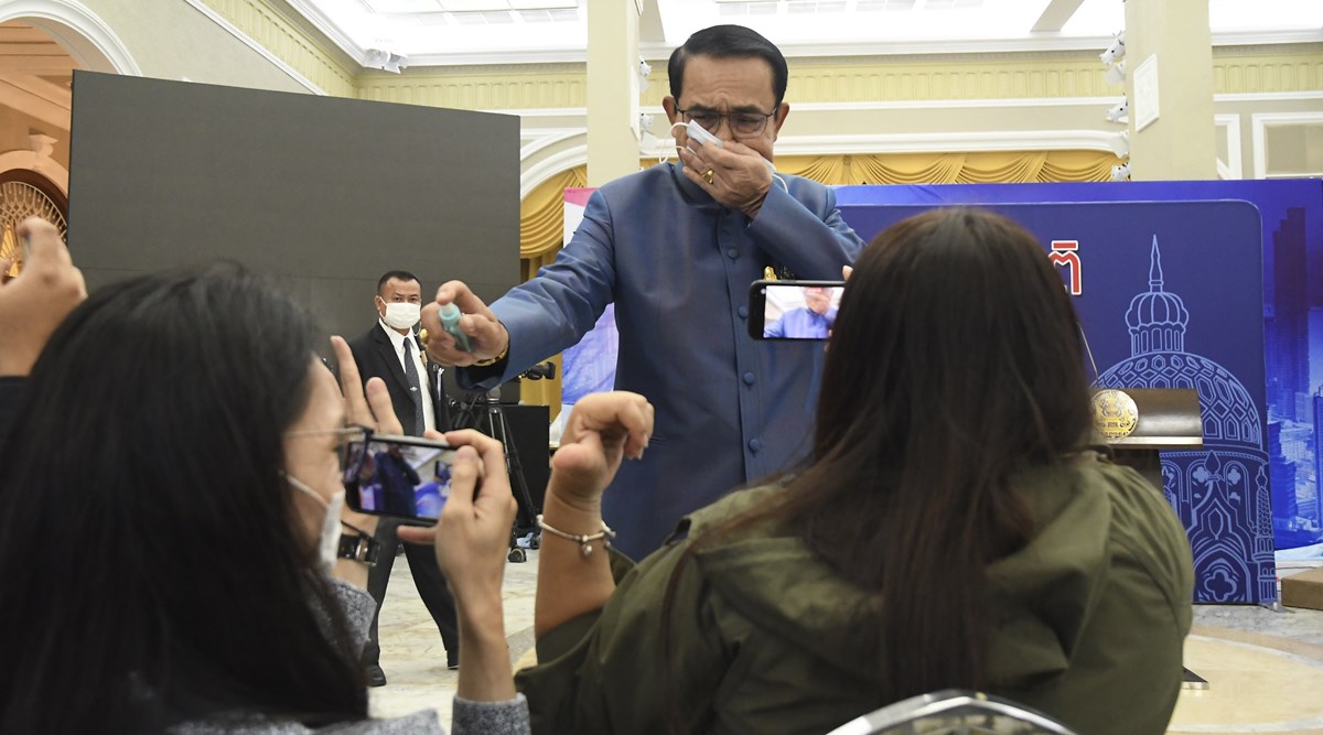 Prayuth Chan-ocha, thai pm sanitiser on journalist, to evade question thai pm spray sanitiser, dodge question pm spray sanitiser, viral video, indian express news