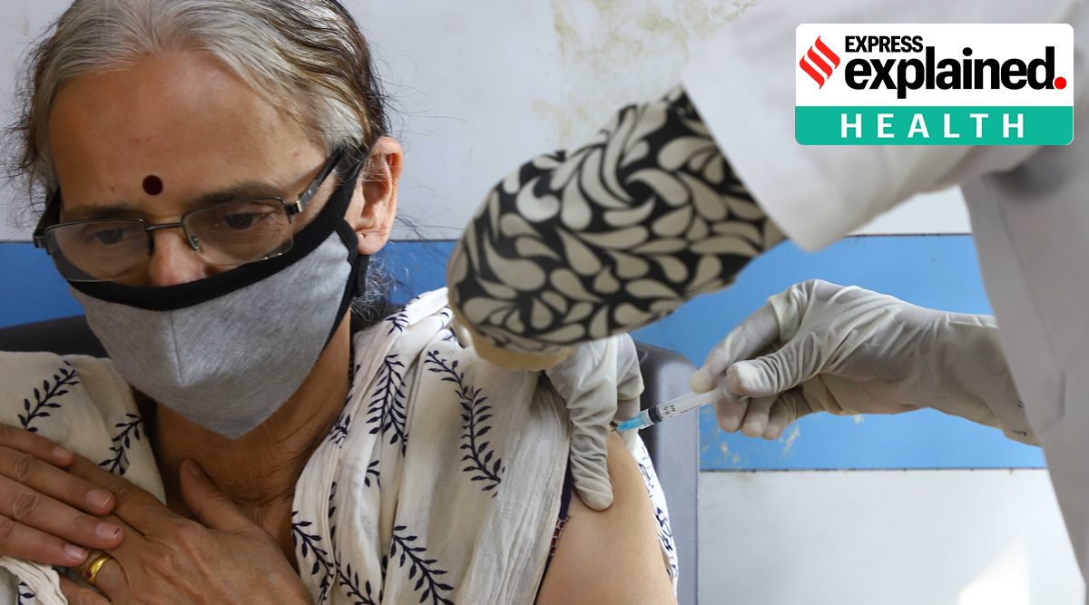 A woman is vaccinated against Covid-19 in Pune (Express Photo: Pavan Khengre)