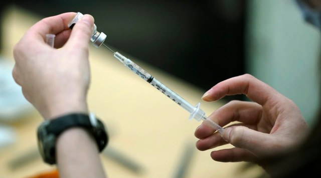 A worker fills a syringe with the Pfizer COVID-19 vaccine at the Yakima Valley Farm Workers Clinic in Toppenish, Wash., Thursday, March 25, 2021. (AP Photo/Ted S. Warren, File)
